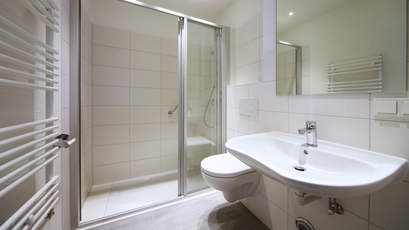 weißes Bad mit Waschbecken und Dusche